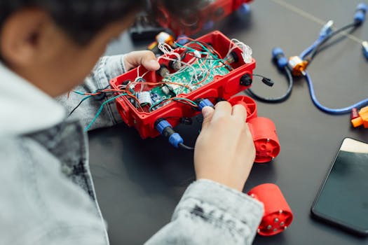 pexels-photo-7869034-7869034 A child actively assembling a robotics project with electronic components, showcasing technology education.